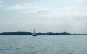 sailboat-on-water-cloudy-sky