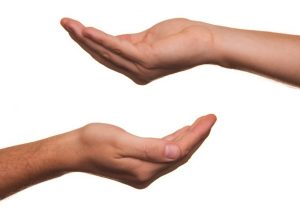 two-hands-reaching-out-on-white-background